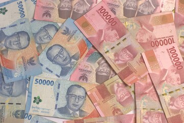 Obraz premium Pile Of Indonesian Rupiah Banknotes IDR 100000 and 50000 Denominations For Business And Financial Concept