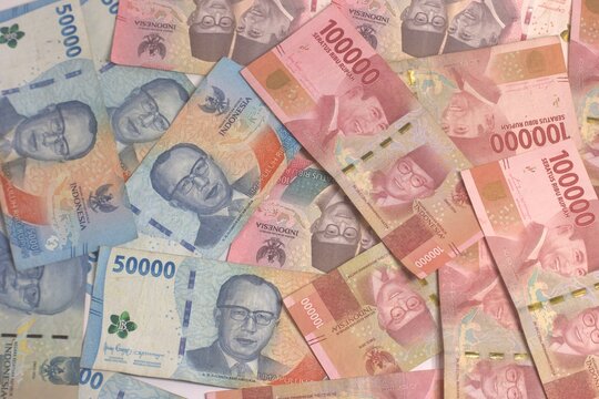 Pile Of Indonesian Rupiah Banknotes IDR 100000 and 50000 Denominations For Business And Financial Concept