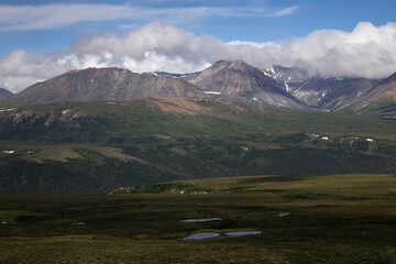 Sun shining on mountains on a summer day in Alaska