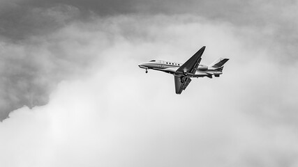 Private Jet Flying Through Cloudy Sky