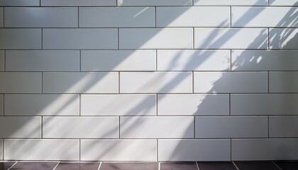 white glossy subway tile wall with sunlight shadows on bright modern surface