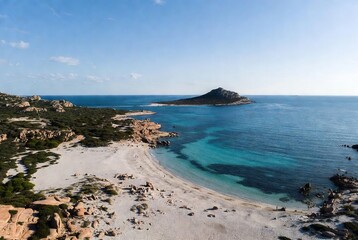 Aerial view of a pristine white sand beach and turquoise sea meeting a rugged coastline