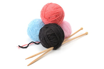 Four Yarn Balls in Red Black Blue Pink with Wooden Needles Arranged for Craft Presentation