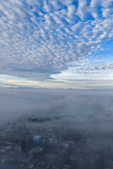 Obraz premium Aerial View Over Cloud Layer With Mountain Horizon And Beautiful Blue Sky At Dawn Today