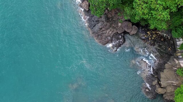 Drone Footage of White Sandy Beach Along Tropical Green Forest Coastline in Malang, Indonesia