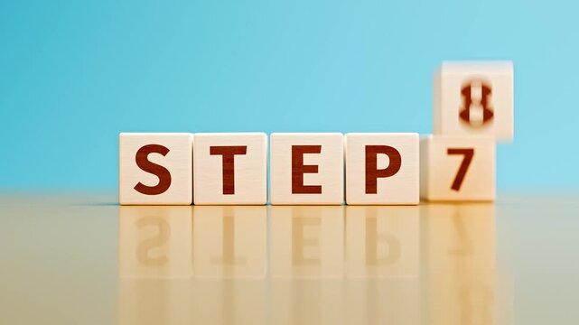 Counting from "STEP 1" to "STEP 9" with wooden toy cubes - next steps falling down and moving to the back. Concept for process steps.