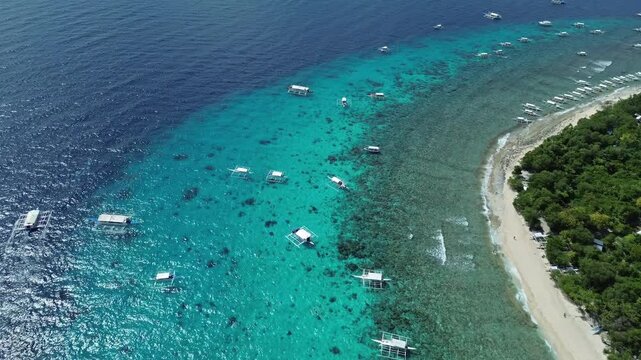 Aerial view of tropical island Balicasag beach, turquoise waters and coral reefs, Philippines, 4k