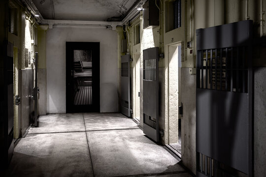 Hong Kong, China. Interior corridor of the former Central Police Station prison at Tai Kwun, showing barred cell doors and the preserved architecture of the detention block.