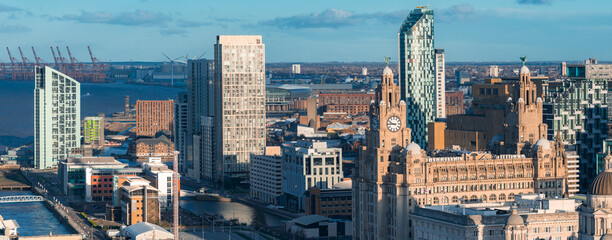 Aerial sunrise view of Liverpool, UK, with the Royal Liver Building, clock towers, River Mersey,...