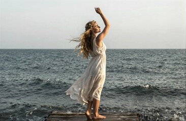 Woman in white dress feeling freedom by ocean