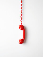 Bright Red Vintage Telephone Receiver Hanging with Coil Cord