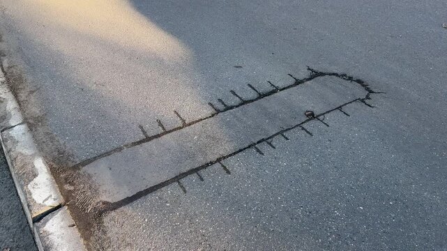 Place of selection of the kernel in the form of a rectangular from asphalt concrete pavement. Kern. Close-up.