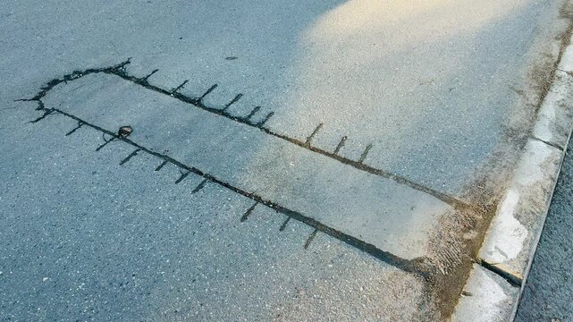 Place of selection of the kernel in the form of a rectangular from asphalt concrete pavement. Kern. Close-up.