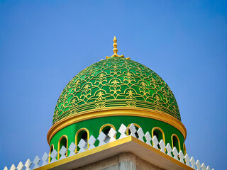 Beautiful green dome of a mosque with blue sky background   © Chitro Stock 