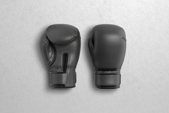Blank black boxing gloves pair mockup lying, grey background
