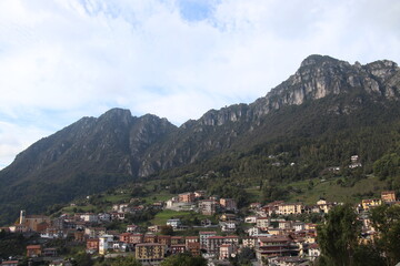 igh-angle panoramic view of the alpine village of Lodrino, situated in the Val Trompia valley, Brescia province. The images capture the traditional Italian mountain architecture, green hillsides