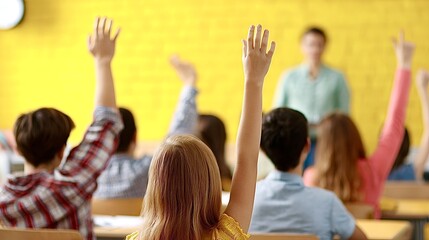 Fototapeta premium Students raising hands participating in a classroom lesson