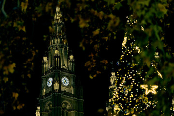 Vienna City Hall Tower and Festive Christmas Tree Display at Night.