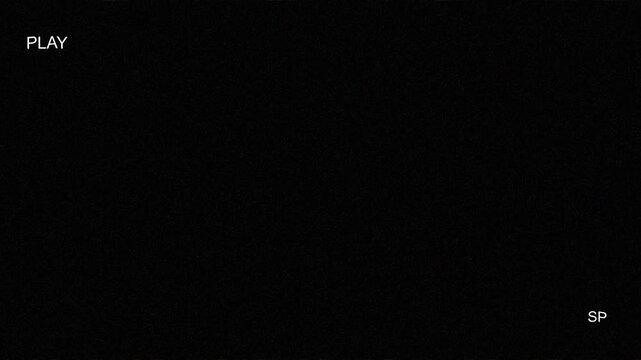 Retro visual of tape playing vhs with a worn out play vhs indicator, enhanced by scanlines and old school VHS distortion on a black screen.