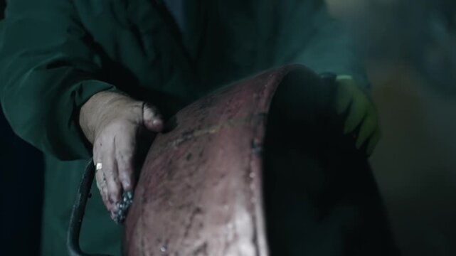 Man is cleaning a copper boiler of homemade distillery. Making moonshine schnapps, alcoholic beverages such as brandy, cognac, whiskey, bourbon, gin, and scotch, slow motion