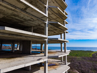 Construction site near the ocean shows empty levels and blue sky during daytime at a coastal...