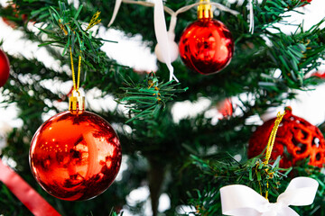 Red Christmas Ornaments Hanging on Green Pine Tree Branch