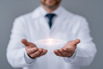 Doctor holding holographic circular interface projection above palms conveying medical technology innovation and patient care