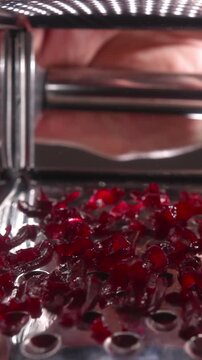 Crimson beet pieces on surface, Vivid crimson beet fragments descend onto perforated stainless surface