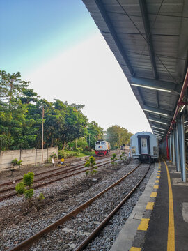 Probolinggo, Indonesia - October 10, 2025 : A KAI locomotive and passenger car wait on parallel tracks at a Probolinggo station, prepared to embark on a journey through the scenic East Java landscape