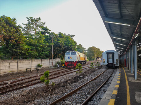 Probolinggo, Indonesia - October 10, 2025 : A KAI locomotive and passenger car wait on parallel tracks at a Probolinggo station, prepared to embark on a journey through the scenic East Java landscape
