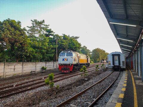Probolinggo, Indonesia - October 10, 2025 : A KAI locomotive and passenger car wait on parallel tracks at a Probolinggo station, prepared to embark on a journey through the scenic East Java landscape