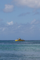 Naklejka premium Carribean Sea Boat Aqua Morning sky ocean