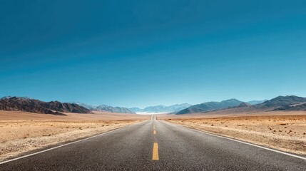a long, straight road stretching into the distance against a clear sky. the road is devoid of vehicles, emphasizing its vast length