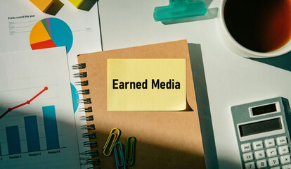 There is sticky note with the word Earned Media. It is as an eye-catching image.