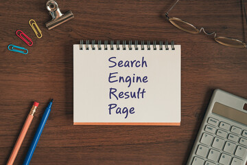 There is notebook with the word Search Engine Result Page. It is as an eye-catching image.