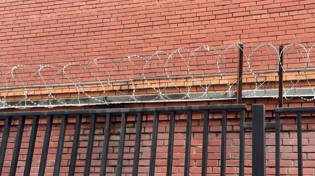 Metal Railing Atop Brick Wall CloseUp Tight Composition Highlighting Parallel Bars And Mortar Lines Subtle Weathering Horizontal Rhythm Muted Color Palette Architectural Detail