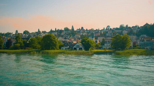 Suburban area near Zurich lake with houses, trees, and calm residential surroundings.
