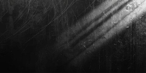 Abstract dark grunge background with a vintage black chalkboard texture on an old dirty wall surface providing a blank gray backdrop for design copy space