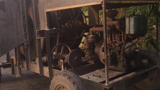 Workers using a machine to mix asphalt, Close up of a Bitumen Mixing Machine OR Asphalt Mixer, it is widely used in India and road construction contexts.