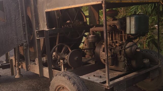 Workers using a machine to mix asphalt, Close up of a Bitumen Mixing Machine OR Asphalt Mixer, it is widely used in India and road construction contexts.