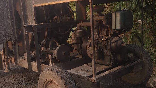 Workers using a machine to mix asphalt, Close up of a Bitumen Mixing Machine OR Asphalt Mixer, it is widely used in India and road construction contexts.