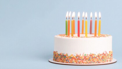 Festive White Birthday Cake with Rainbow Sprinkles and Lit Candles