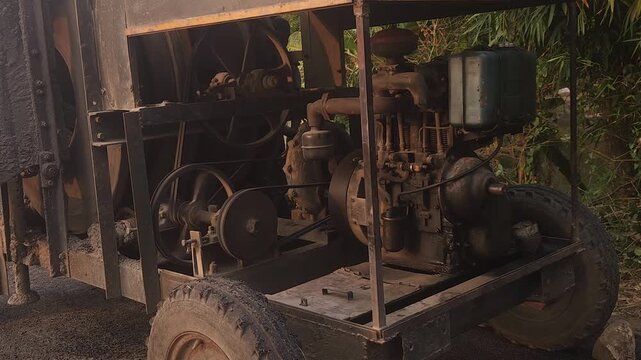 Workers using a machine to mix asphalt, Close up of a Bitumen Mixing Machine OR Asphalt Mixer, it is widely used in India and road construction contexts.