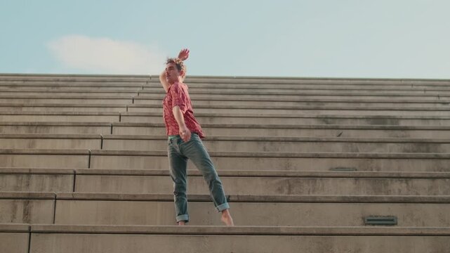 Young Man Dancing Barefoot Outdoors On Steps