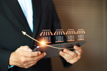 Businessman with franchise icon for goal to growth is investment planning financial and branch expansion and management bank loans for marketing franchising.