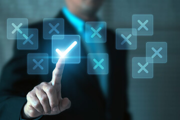 Human hand touchscreen check mark with cross symbol on wooden toy stack for true or false changing mindset or way of adapting to change leader and transform quiz answer and poll concept.