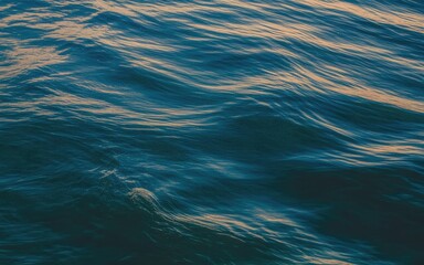 Calm ocean waves with gentle ripples and sunlight reflections on blue water surface in serene natural environment with sea and peaceful and tranquil