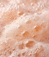 Background with macro peach colored foam bubbles creating an abstract pattern	
