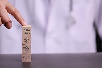 Doctor hand touching wooden block stack showing minimal balance concept for good healthcare and physical wellness stability in life