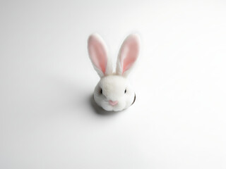 Minimalist Easter Bunny Ears Peeking from Torn Paper Hole on Clean White Background with Copy Space, Simple Spring Holiday Concept
